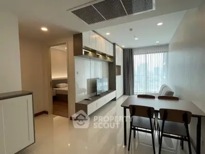 Modern living room with dining area and city view, featuring sleek furniture and natural light.