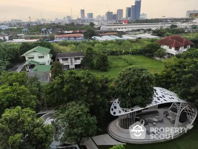 Stunning aerial view of lush green garden with modern gazebo and city skyline backdrop