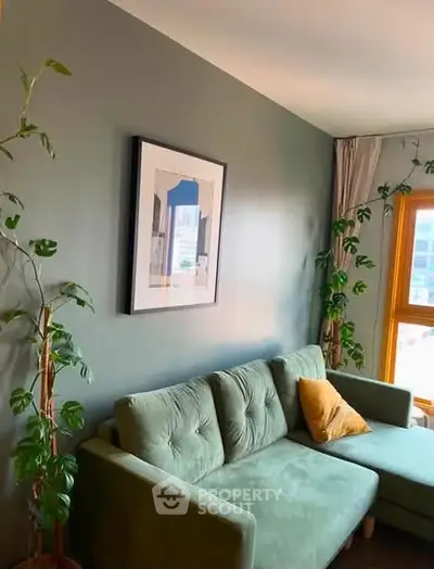 Stylish living room with green sofa and modern decor, perfect for relaxation and comfort.