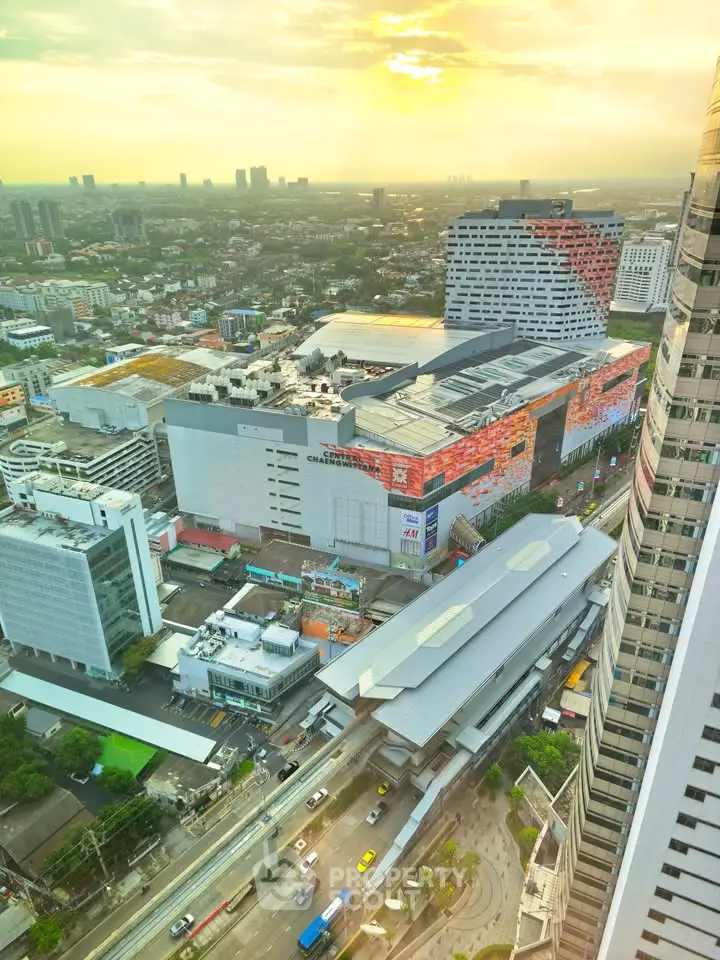 Stunning aerial view of a vibrant cityscape with modern architecture and bustling streets at sunset.