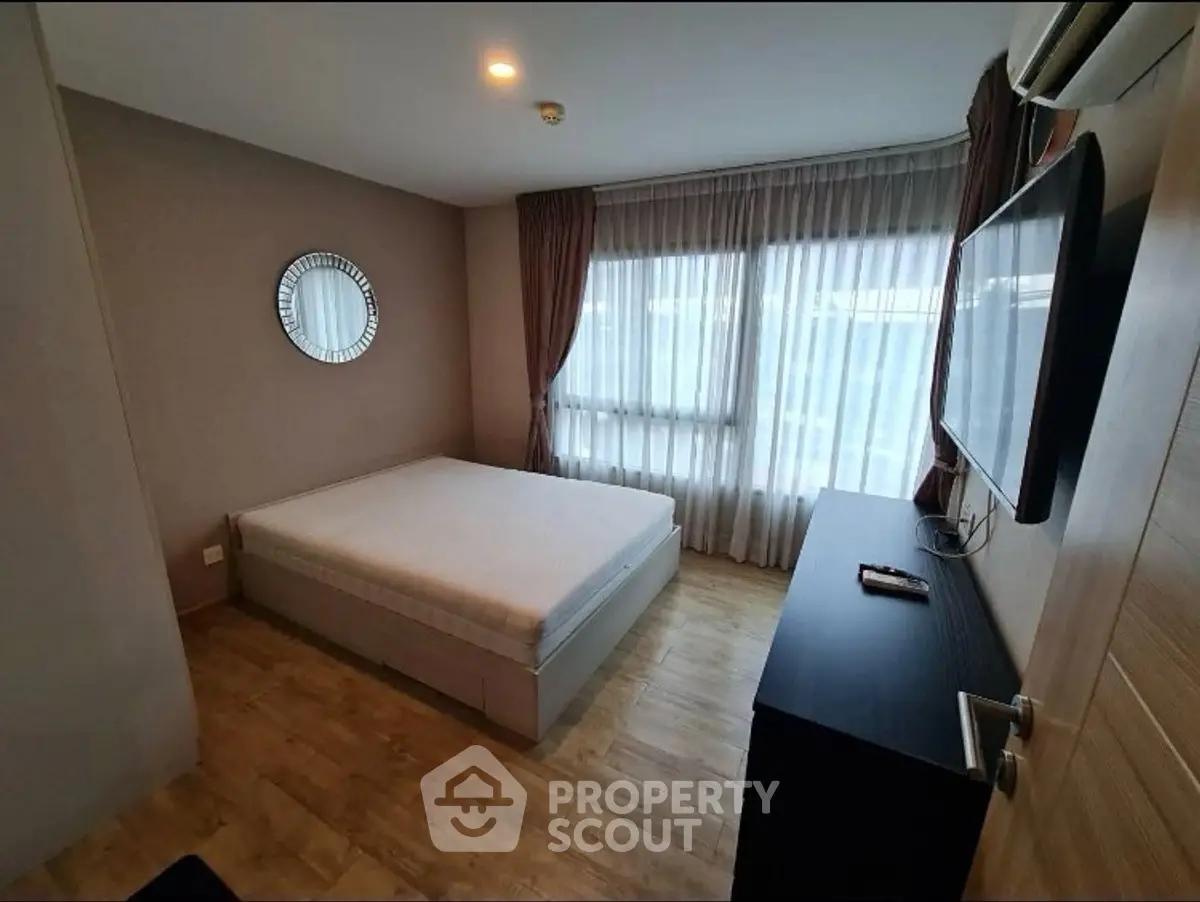 Modern bedroom with large window and stylish decor