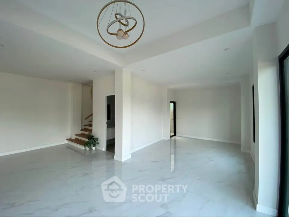 Spacious modern living room with elegant lighting and marble flooring