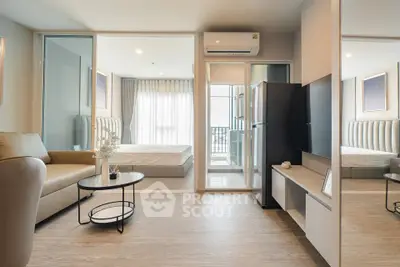 Modern open-plan living room with sleek furniture and natural light