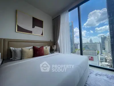 Luxurious bedroom with stunning city view and modern decor in high-rise apartment.