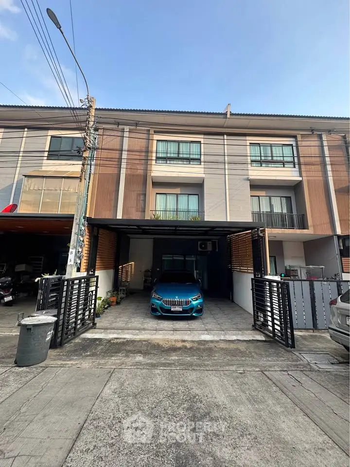 Modern townhouse with carport and sleek facade in urban setting