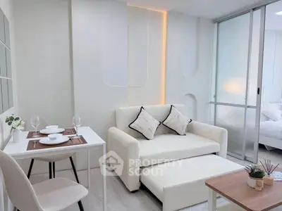 Modern living room with sleek white decor and cozy seating area