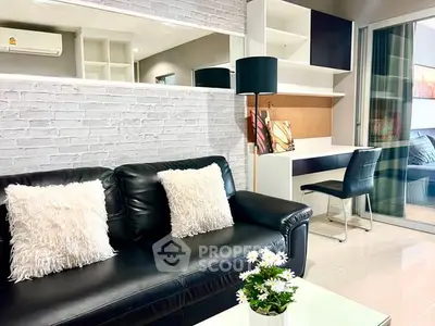 Modern living room with black leather sofa and stylish decor