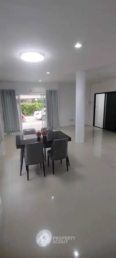 Spacious modern living room with dining area and large windows for natural light.