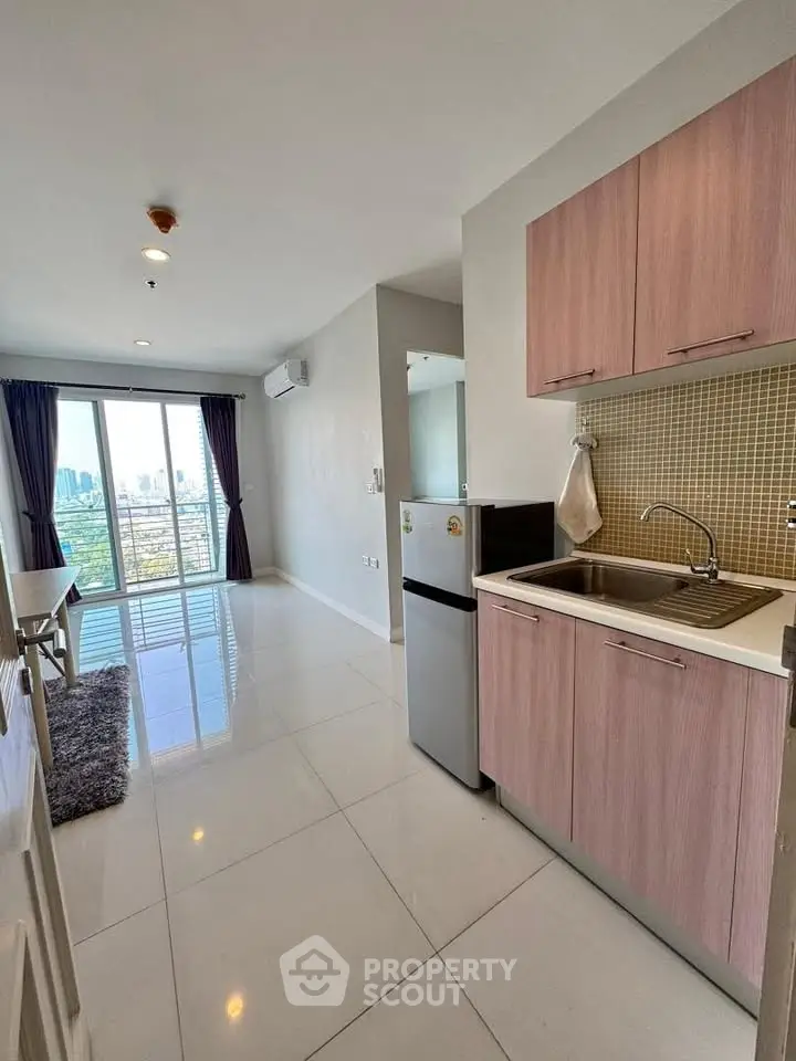 Modern apartment kitchen with city view, sleek cabinetry, and open layout.