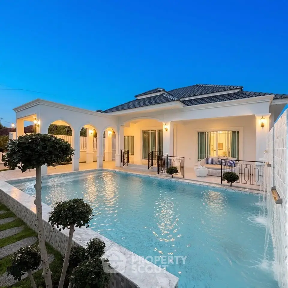 Luxurious villa with stunning pool and elegant architecture at twilight.