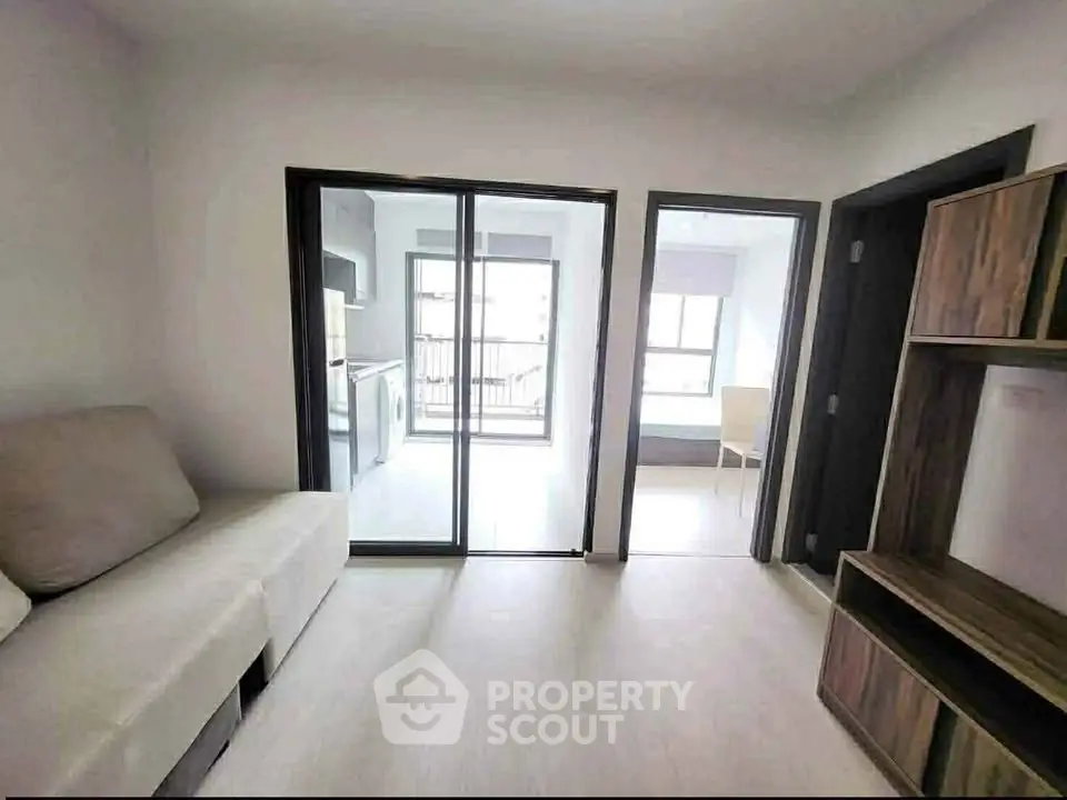 Modern apartment interior with sliding glass doors and cozy furniture