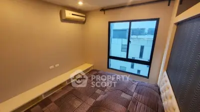 Cozy bedroom with modern air conditioning and city view window