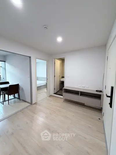 Modern apartment interior with open layout and light wood flooring