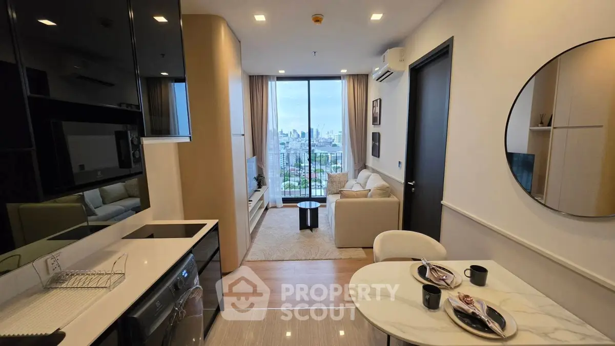 Modern apartment interior with open kitchen and stunning city view from living room balcony.