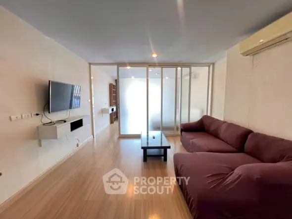 Spacious living room with modern decor and large sofa, perfect for relaxation.