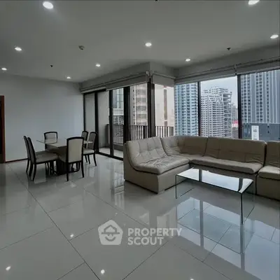 Spacious modern living room with city view and elegant dining area.