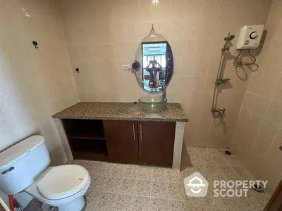 Spacious bathroom with modern fixtures and elegant tile design, featuring a stylish vanity and shower area.