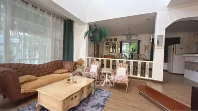 Charming living room with vintage furniture and open layout, perfect for cozy gatherings.