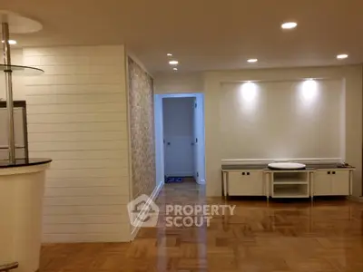 Spacious modern interior with wooden flooring and elegant lighting