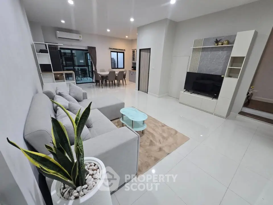 Spacious modern living room with sleek furniture and open layout, perfect for entertaining.