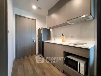 Modern kitchen with sleek cabinetry and appliances in a stylish apartment.
