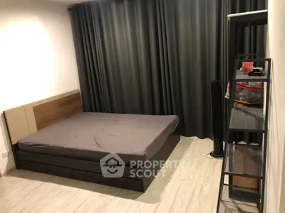 Modern bedroom with sleek design, featuring a comfortable bed and stylish shelving unit.