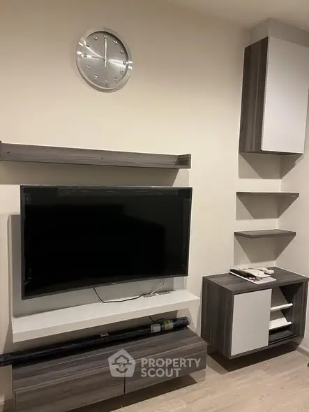 Modern living room with sleek TV setup and stylish shelving