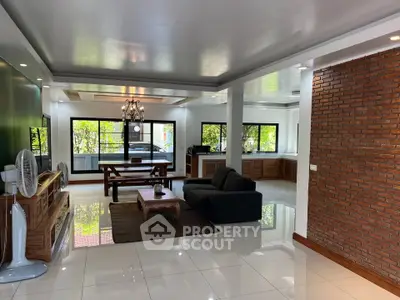Spacious modern living room with brick accent wall and large windows