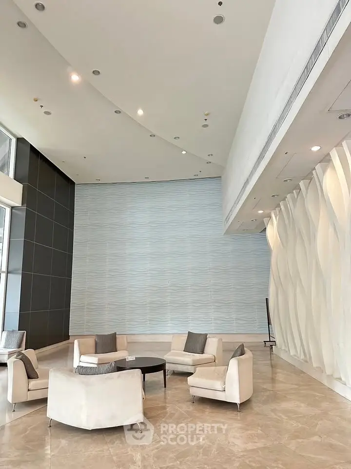 Luxurious modern lobby with elegant seating and stylish wall design in a high-end building.