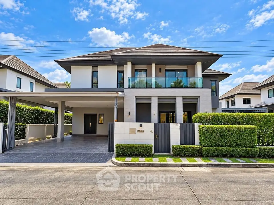 Modern two-story house with spacious driveway and lush greenery, perfect for family living.