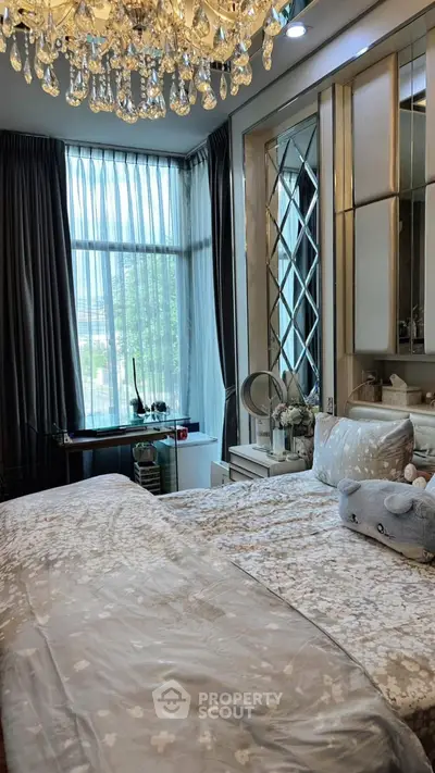 Luxurious bedroom with elegant chandelier and large window view
