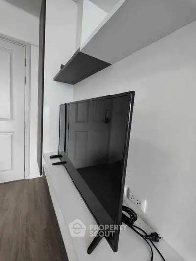 Modern living room with sleek TV setup and stylish shelving