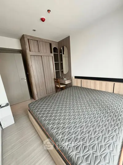 Modern bedroom with stylish wooden furniture and cozy bed in a contemporary apartment.