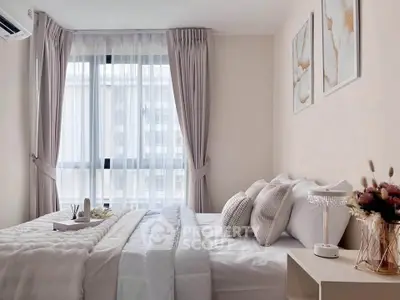 Elegant bedroom with modern decor and large window, featuring cozy bedding and stylish artwork.