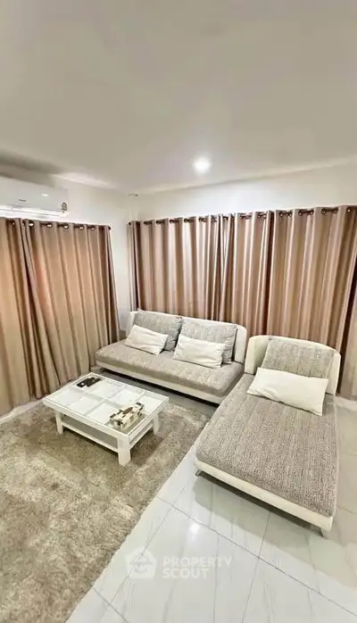 Elegant living room with modern furniture and cozy ambiance, perfect for relaxation and entertainment.
