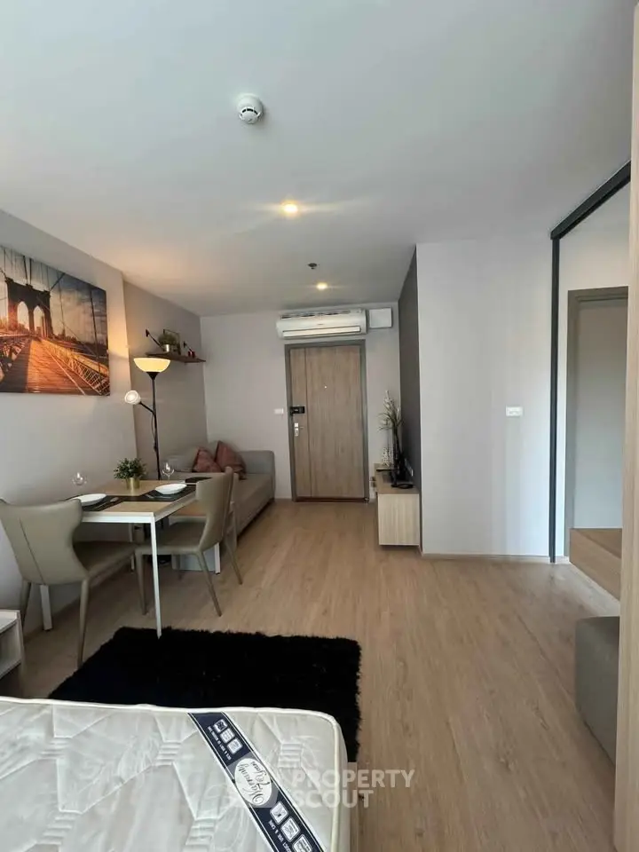Modern living room with dining area and stylish decor in a cozy apartment.