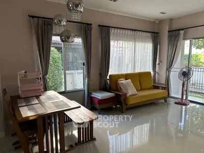 Bright living room with modern decor, large windows, and stylish furniture in a cozy home setting.
