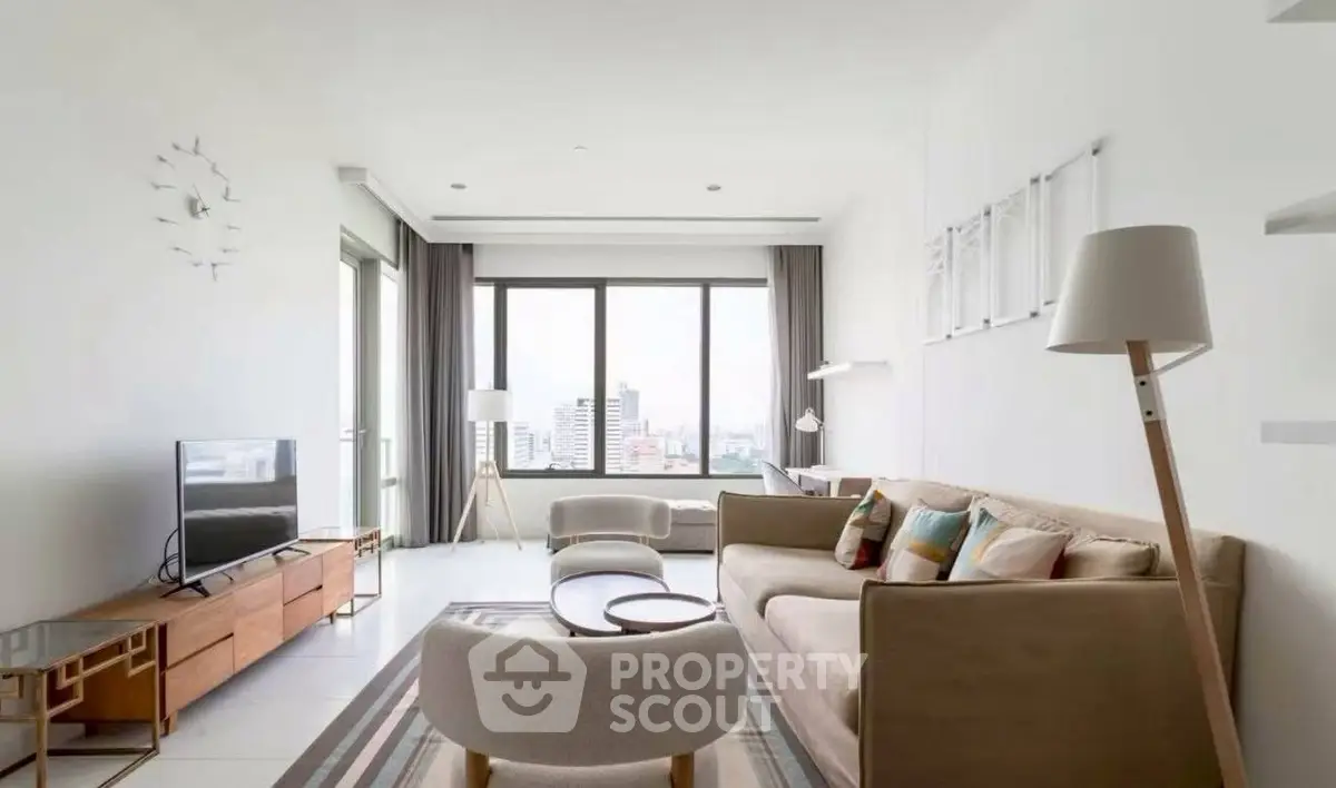 Spacious modern living room with city view, stylish furniture, and natural light.
