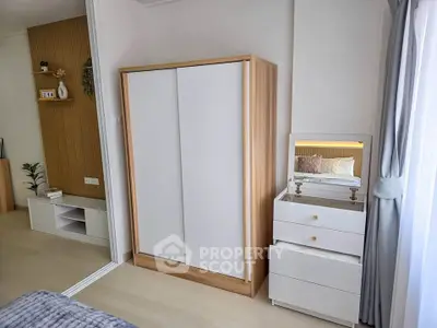 Modern bedroom with sleek wardrobe and stylish vanity in a bright, airy space.