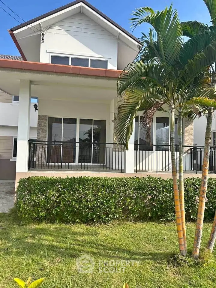 Charming suburban home with lush garden and spacious porch, perfect for family living.