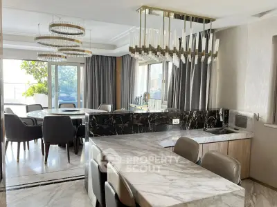 Luxurious dining area with marble countertops and elegant lighting in a modern apartment.