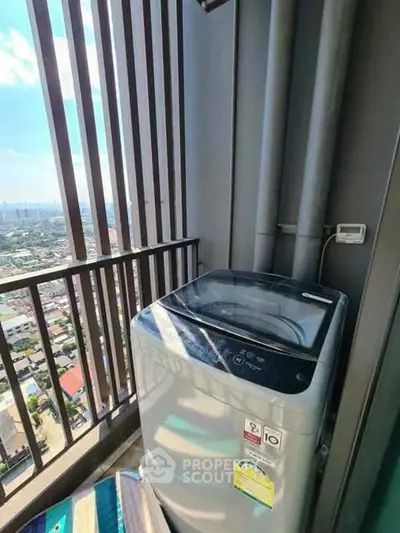 High-rise balcony with washing machine and city view, perfect for urban living convenience.