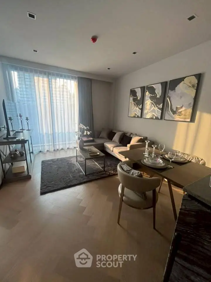 Elegant living room with modern decor and large windows offering natural light.