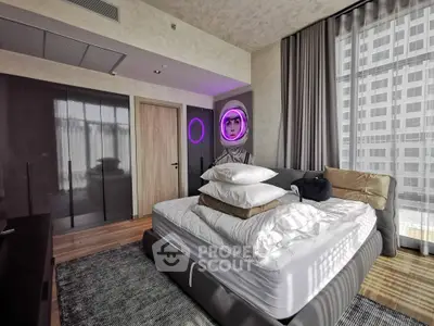 Modern bedroom with stylish decor and large windows offering city views.