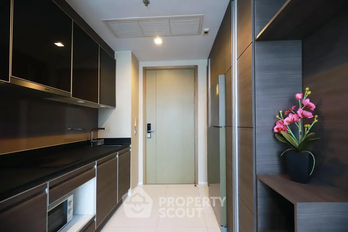 Modern kitchen with sleek cabinetry and elegant decor in a stylish apartment.