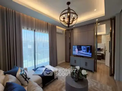 Luxurious living room with elegant decor and modern lighting, featuring a cozy seating area and a flat-screen TV.