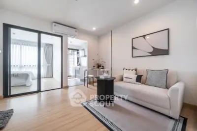Modern open-plan living room with stylish decor and natural light