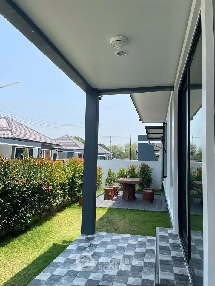 Charming modern home exterior with lush garden and stylish patio area.