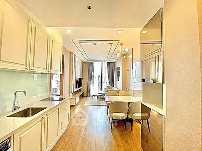 Modern open-layout kitchen and living room with elegant furnishings and natural light.