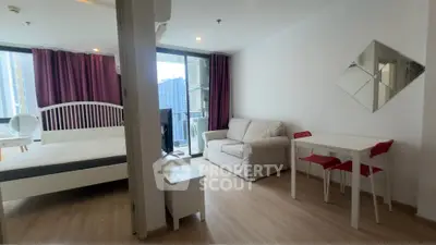 Modern studio apartment with cozy living area and balcony view